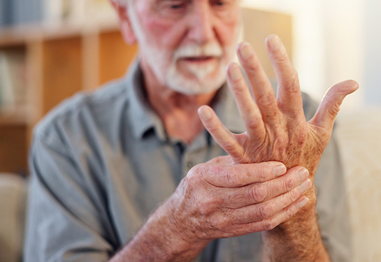 Senior, man and hands pain in home, arthritis and osteoporosis and muscle issue for healthcare.